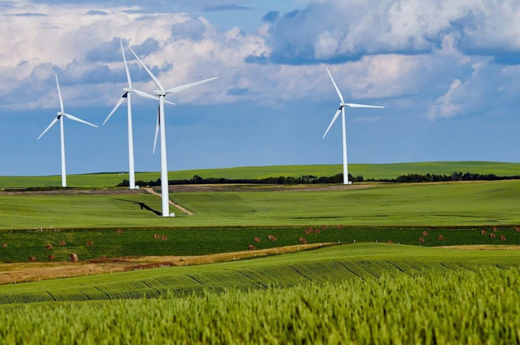 Windmills on a rural farm landscape representing long-term asset use decisions similar to Buyout Your Lease and evaluating ownership versus leasing options.