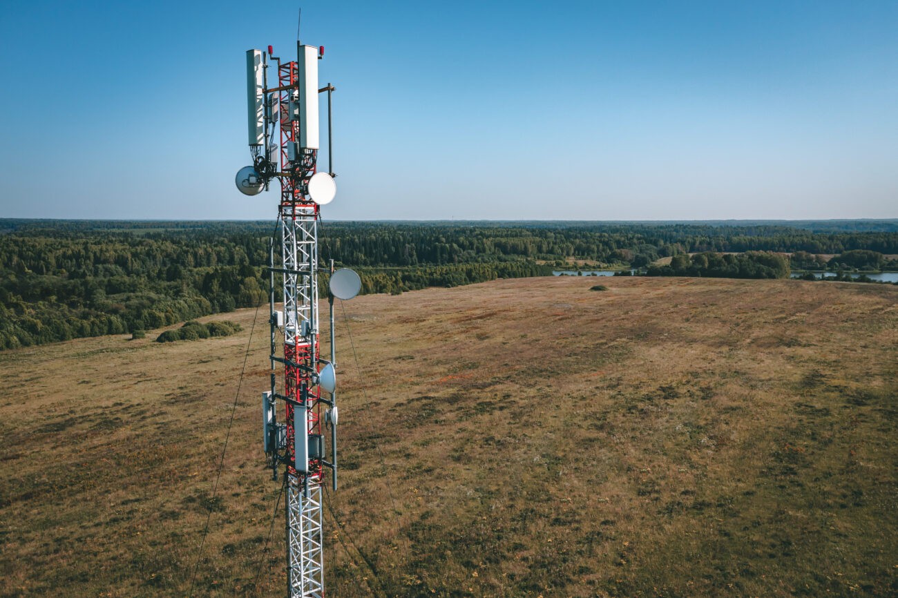 Cell tower standing on a hilltop, representing the financial opportunity of a cell tower lease buyout for landowners.