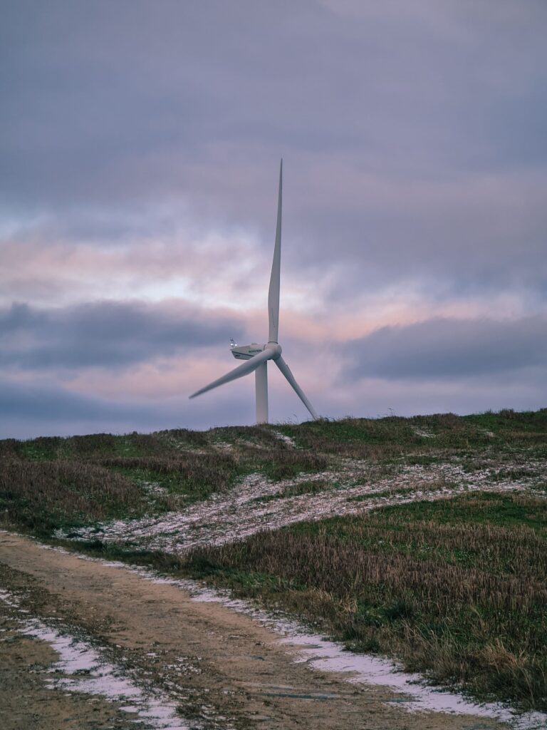 beautiful-shot-of-a-wind-turbine-in-a-wind-farm-2025-02-08-14-02-15-utc » GAMZs Ground Lease Buyout Wind turbine standing on a wide open grassy field, symbolizing financial decisions like Buyout Your Lease in a changing economic environment.