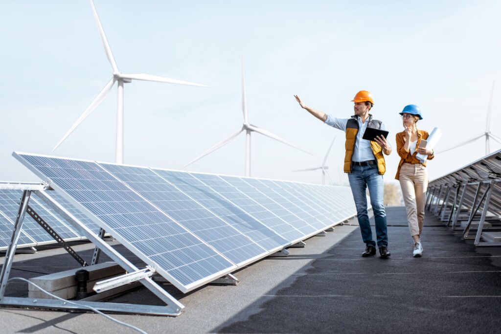 Engineers inspecting solar panels at a utility-scale solar farm operated by Solar farm companies on leased land.