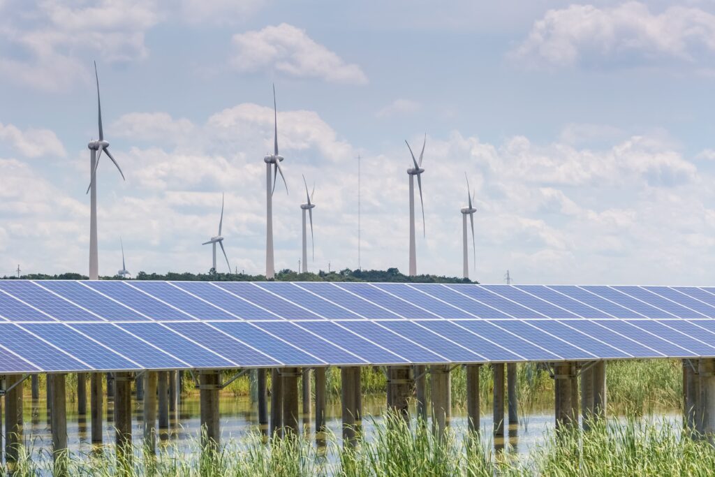Wind farm and solar power station operated by Solar farm companies, illustrating large-scale renewable energy sites tied to ground lease agreements.